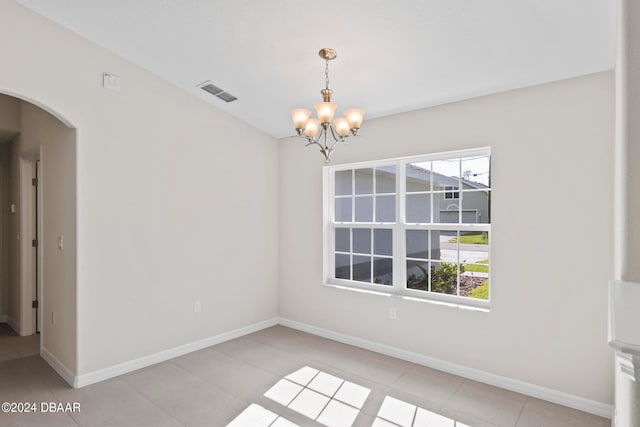 unfurnished room featuring light tile patterned floors and a notable chandelier