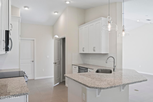 kitchen with stainless steel appliances, white cabinetry, sink, a kitchen bar, and hanging light fixtures