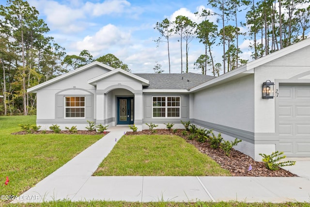 ranch-style home featuring a front yard and a garage