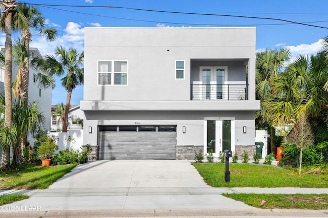 view of front of property featuring french doors, stucco siding, stone siding, and a balcony