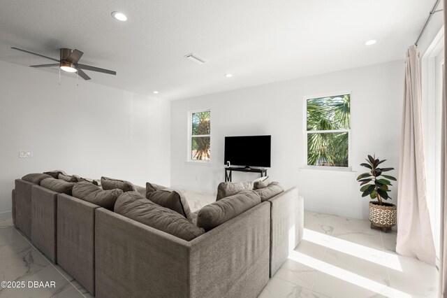 living area featuring recessed lighting, visible vents, marble finish floor, and ceiling fan