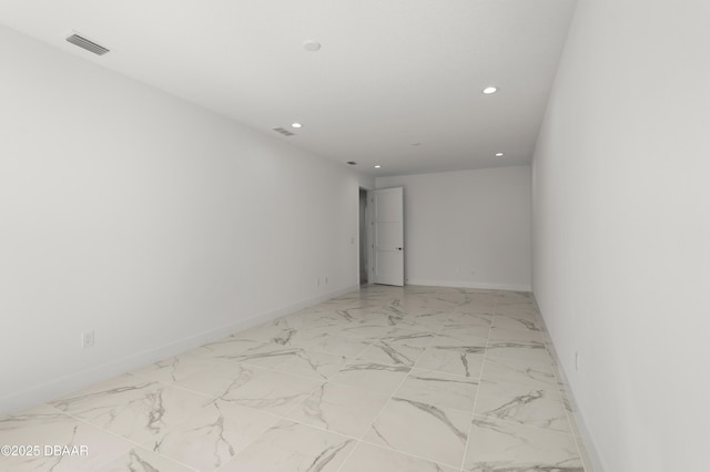 spare room with recessed lighting, visible vents, and baseboards