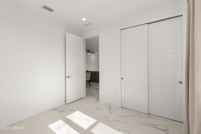 unfurnished bedroom with visible vents, marble finish floor, and baseboards