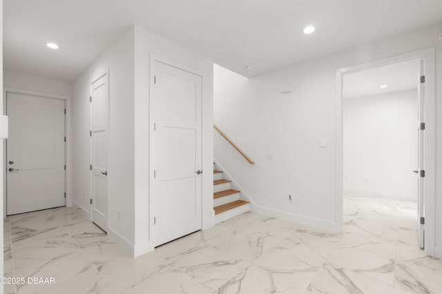 hallway with marble finish floor, stairs, baseboards, and recessed lighting