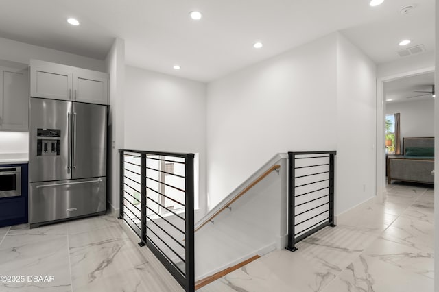 interior space featuring visible vents, baseboards, recessed lighting, and marble finish floor