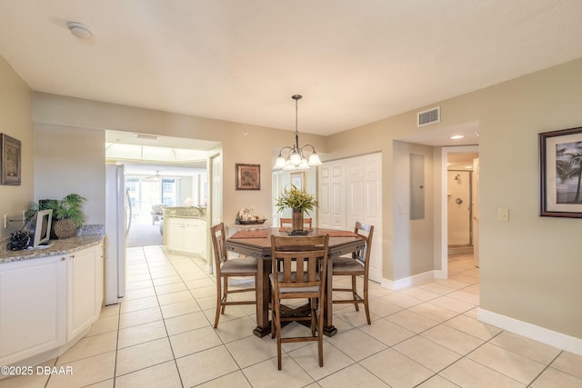 2055 S Atlantic Ave Unit 710, Daytona Beach, FL 32118 - dining room featuring light tile patterned floors, a chandelier, baseboards, and electric panel