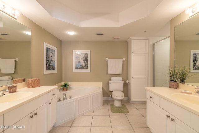 2055 S Atlantic Ave Unit 710, Daytona Beach, FL 32118 - bathroom featuring tile patterned floors, two vanities, a garden tub, and a shower stall