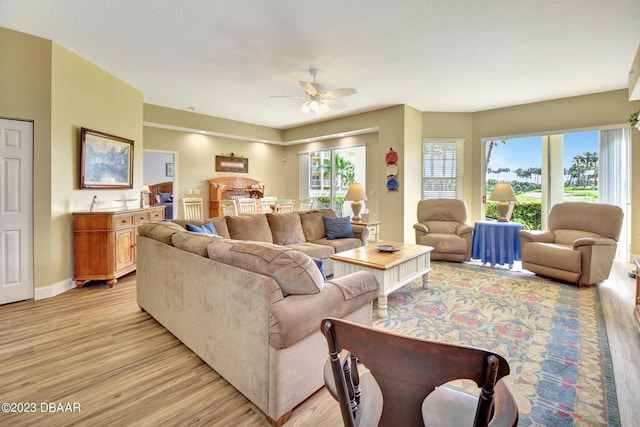 4670 Links Village Dr Unit B102, Ponce Inlet, FL 32127 - living room featuring light wood-style flooring, ceiling fan, and baseboards