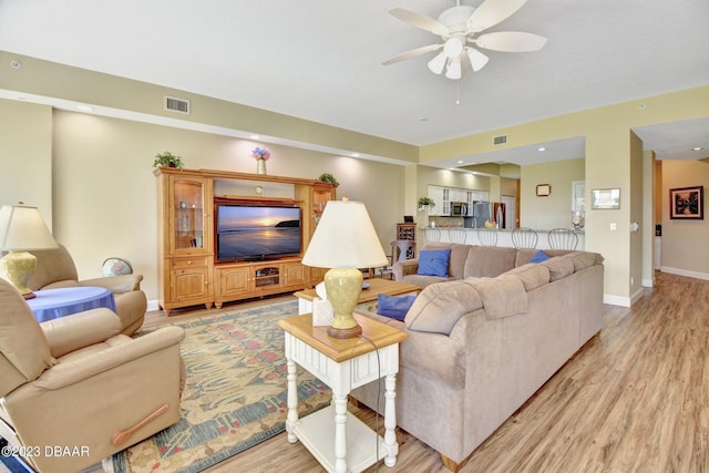 4670 Links Village Dr Unit B102, Ponce Inlet, FL 32127 - living room with light wood-style floors, a ceiling fan, and baseboards