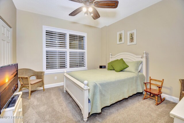 4670 Links Village Dr Unit B102, Ponce Inlet, FL 32127 - bedroom featuring light colored carpet, baseboards, and ceiling fan