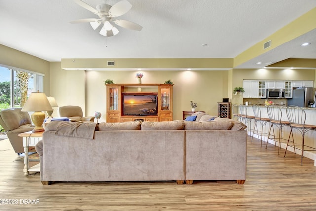 4670 Links Village Dr Unit B102, Ponce Inlet, FL 32127 - living area with light wood finished floors, a ceiling fan, a textured ceiling, and recessed lighting