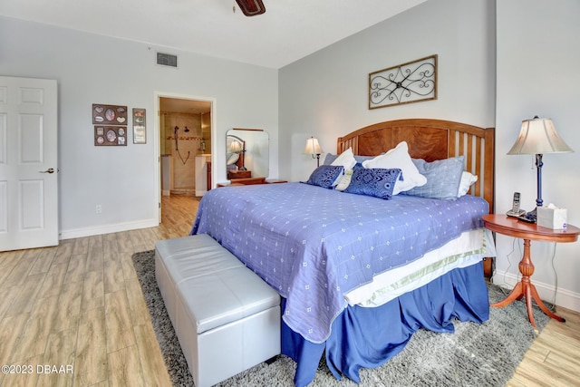 4670 Links Village Dr Unit B102, Ponce Inlet, FL 32127 - bedroom with wood finished floors, baseboards, and ensuite bathroom