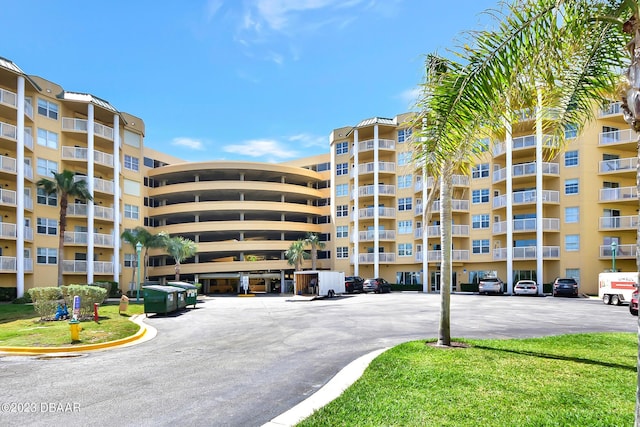 4670 Links Village Dr Unit B102, Ponce Inlet, FL 32127 - view of apartment building / complex featuring uncovered parking