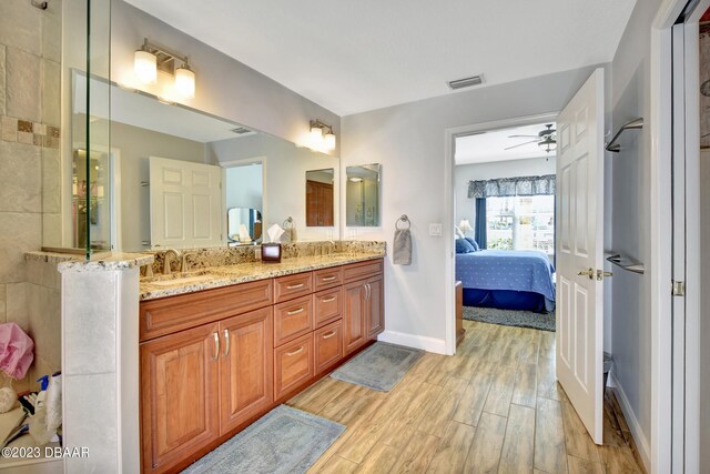 4670 Links Village Dr Unit B102, Ponce Inlet, FL 32127 - bathroom featuring ensuite bathroom, double vanity, wood finished floors, ceiling fan, and baseboards