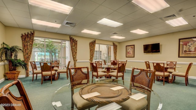 4670 Links Village Dr Unit B102, Ponce Inlet, FL 32127 - dining room with carpet floors, healthy amount of natural light, baseboards, and a paneled ceiling