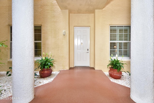 4670 Links Village Dr Unit B102, Ponce Inlet, FL 32127 - doorway to property featuring stucco siding