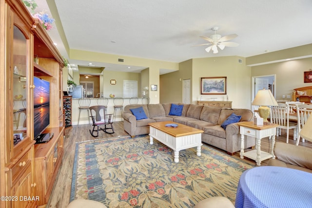 4670 Links Village Dr Unit B102, Ponce Inlet, FL 32127 - living area featuring wood finished floors and a ceiling fan