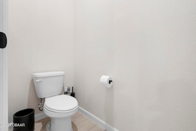 bathroom with wood-type flooring and toilet