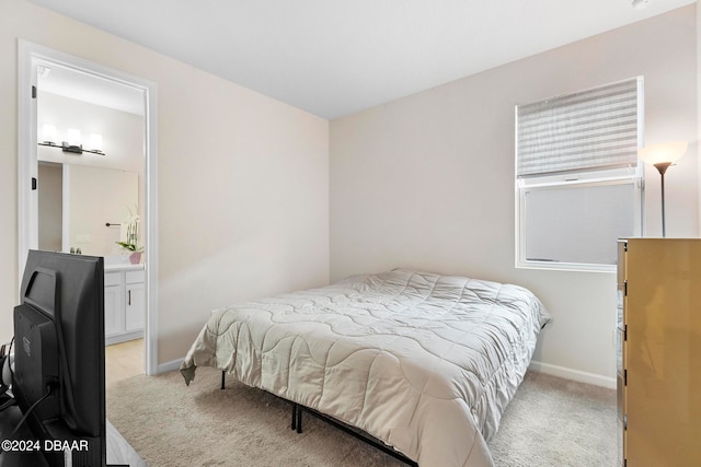 carpeted bedroom featuring connected bathroom