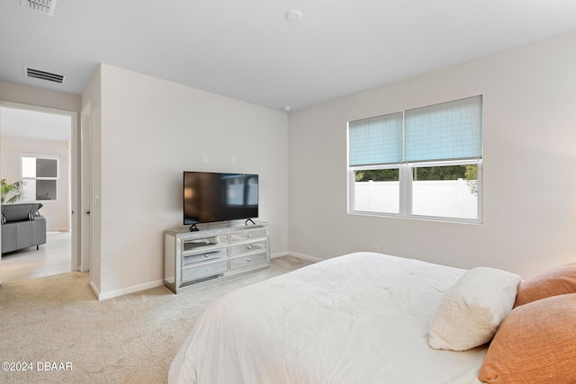 bedroom with light colored carpet