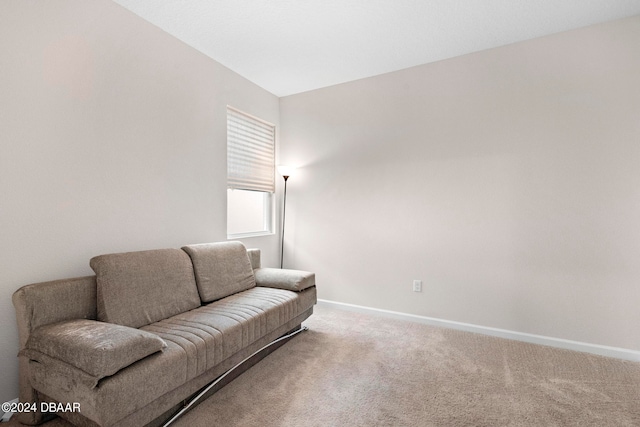 sitting room with lofted ceiling and carpet flooring