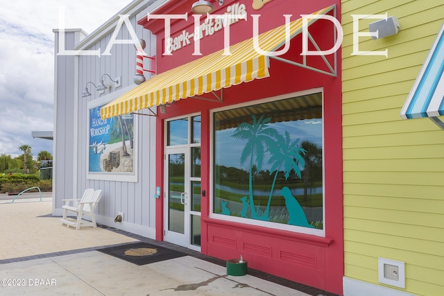838 Attitude Ave, Daytona Beach, FL 32124 - doorway to property with board and batten siding
