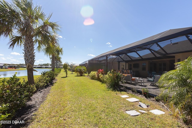 838 Attitude Ave, Daytona Beach, FL 32124 - view of grassy yard with a water view, a patio area, and glass enclosure