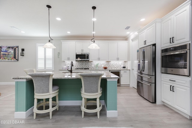 838 Attitude Ave, Daytona Beach, FL 32124 - kitchen featuring appliances with stainless steel finishes, beverage cooler, ornamental molding, white cabinetry, and decorative backsplash