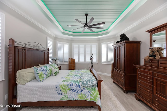 838 Attitude Ave, Daytona Beach, FL 32124 - bedroom with a tray ceiling, light wood finished floors, a ceiling fan, and ornamental molding