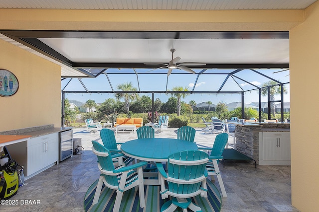 838 Attitude Ave, Daytona Beach, FL 32124 - view of patio / terrace with wine cooler, ceiling fan, a lanai, and exterior kitchen