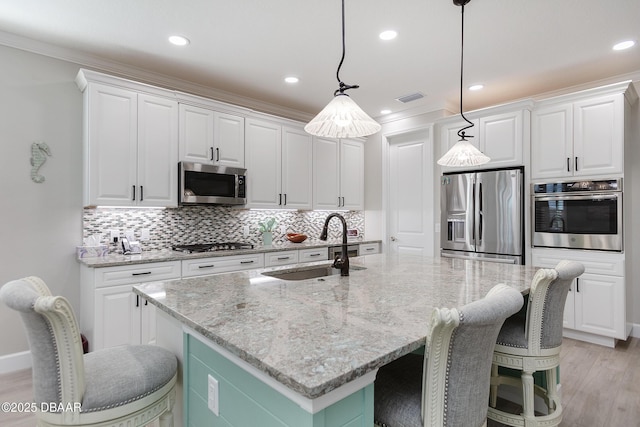 838 Attitude Ave, Daytona Beach, FL 32124 - kitchen featuring appliances with stainless steel finishes, a sink, backsplash, white cabinets, and recessed lighting