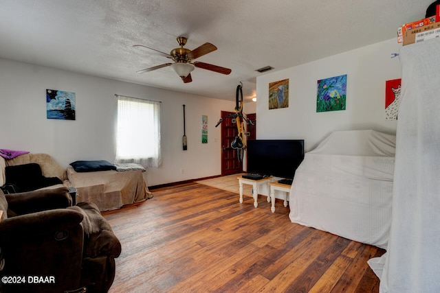 bedroom featuring a textured ceiling, hardwood / wood-style flooring, and ceiling fan