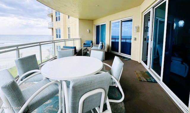 balcony with a beach view and a water view