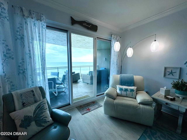 living room with wood-type flooring, a water view, and crown molding