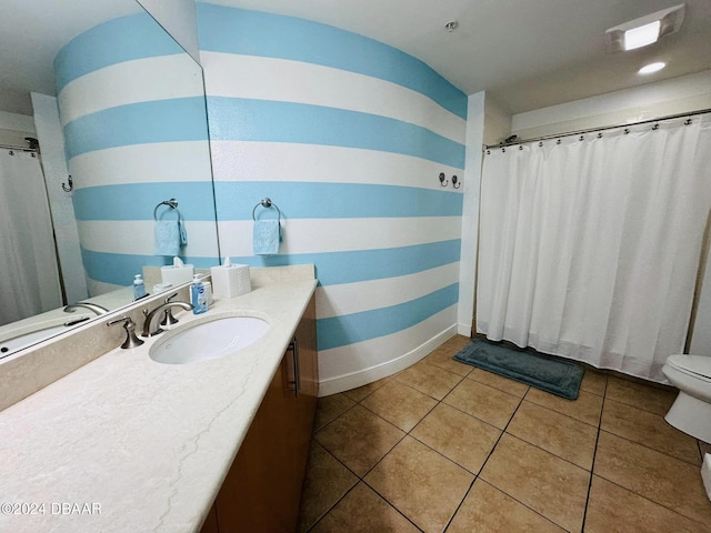 bathroom featuring vanity, tile patterned flooring, and toilet