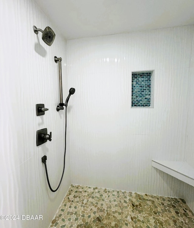 interior details with a tile shower