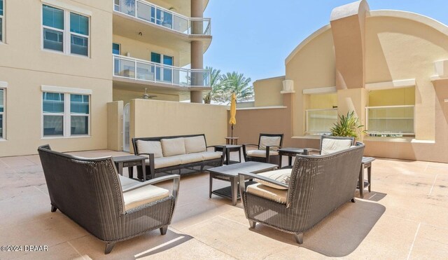 view of patio with a balcony and an outdoor hangout area