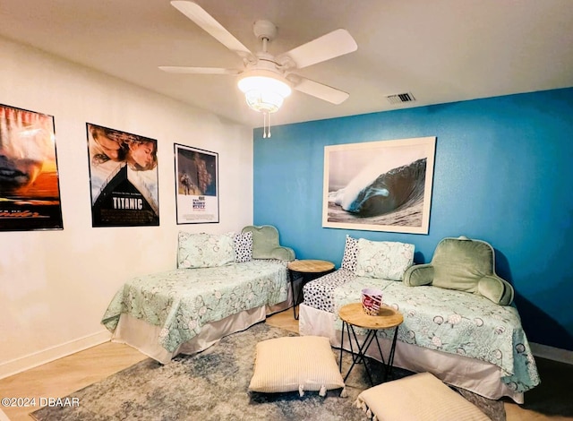 sitting room with light hardwood / wood-style floors and ceiling fan