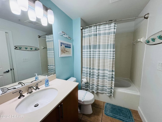 full bathroom featuring vanity, shower / bath combo with shower curtain, tile patterned floors, and toilet