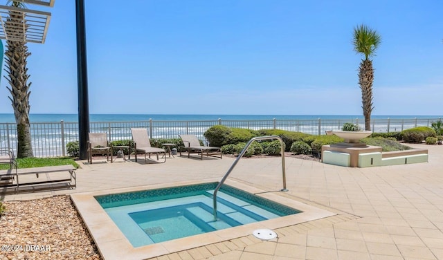 view of swimming pool with a water view, a patio, and a hot tub