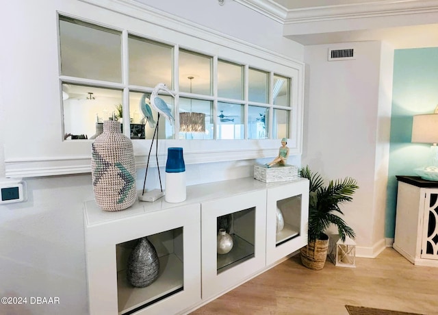 mudroom featuring ornamental molding and light hardwood / wood-style flooring