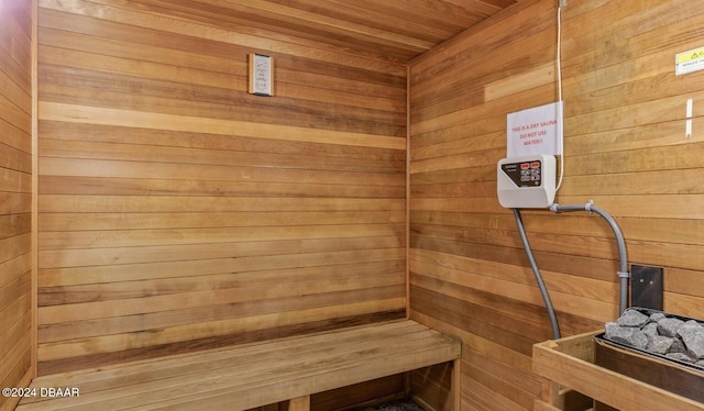 view of sauna with wooden walls and wood ceiling