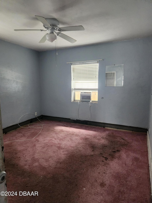 unfurnished room with ceiling fan, cooling unit, and dark carpet