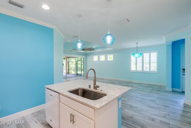 kitchen featuring dishwasher, white cabinets, a wealth of natural light, sink, and an island with sink