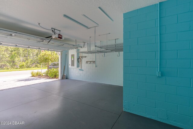 garage featuring a garage door opener and electric panel