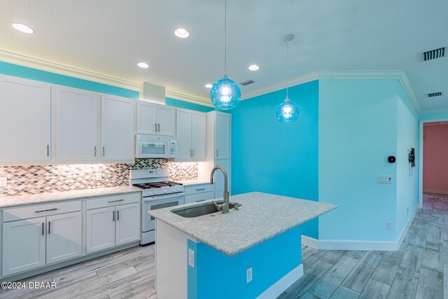 kitchen with white cabinetry, sink, an island with sink, white appliances, and pendant lighting