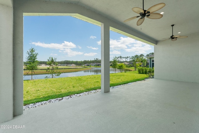 view of patio featuring a water view and ceiling fan