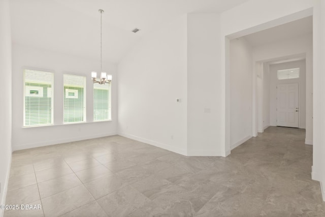 spare room featuring an inviting chandelier and lofted ceiling