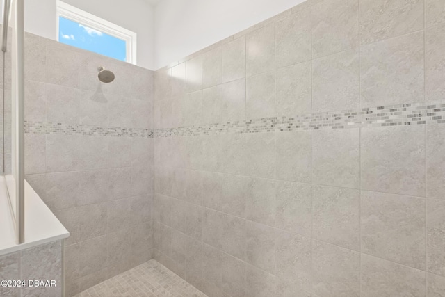 bathroom with tiled shower