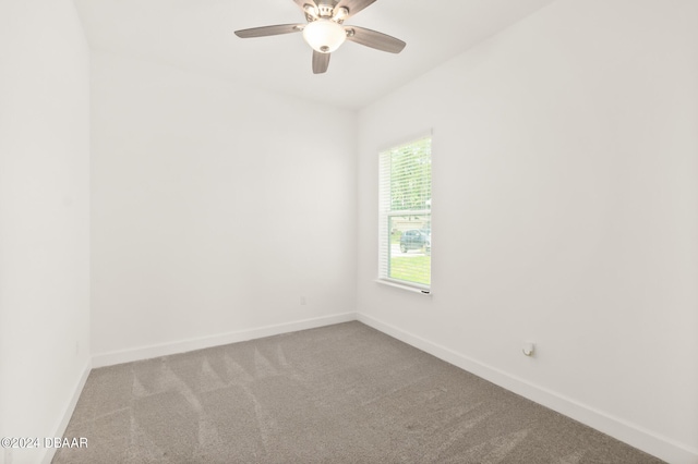 unfurnished room with ceiling fan and carpet